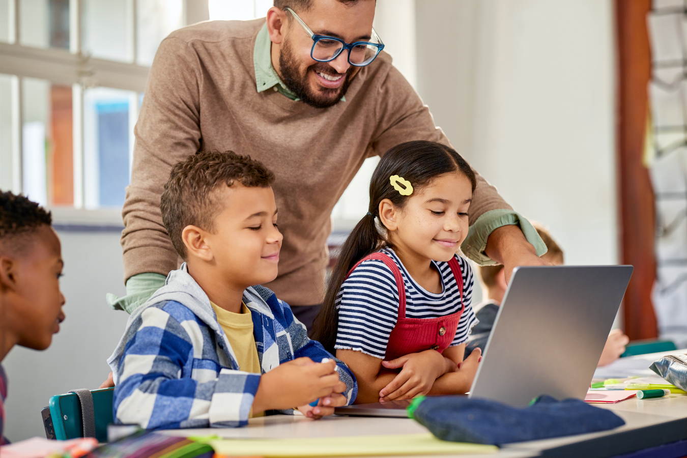 Teacher with computer and students